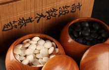 Загрузите изображение в средство просмотра галереи, Wooden bowls with white and black stones against a wooden background with Japanese text.